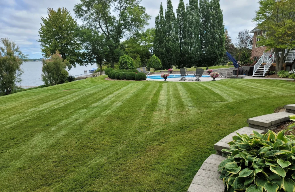 Freshly cut and striped lawn on a waterfront property