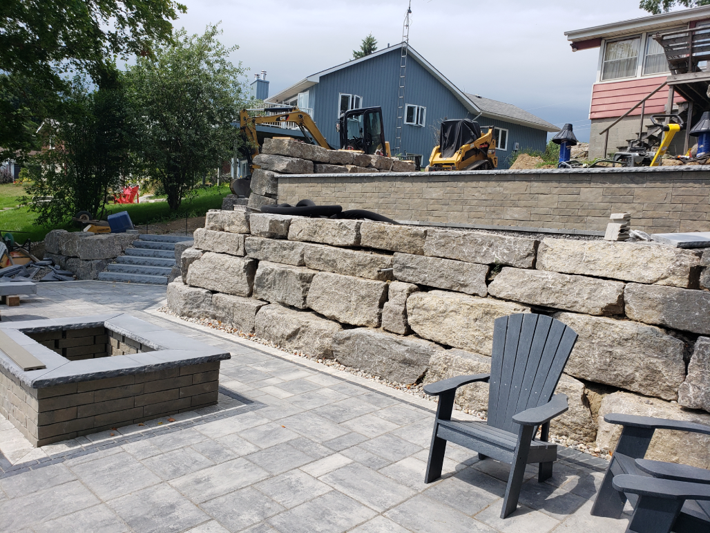 Armour stone retaining wall with a built-in fire pit