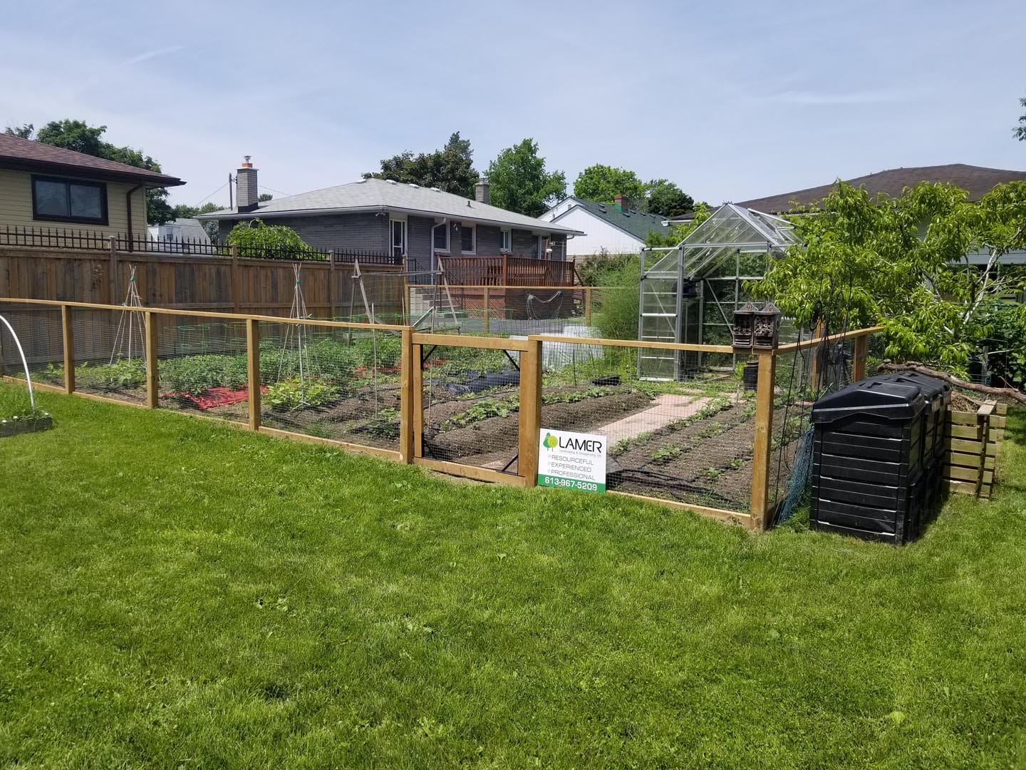 Wood privacy fence behind a planted garden bed