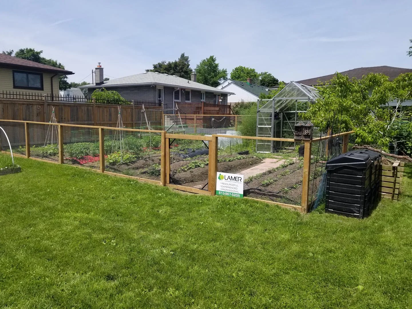 Wood privacy fence behind a planted garden bed