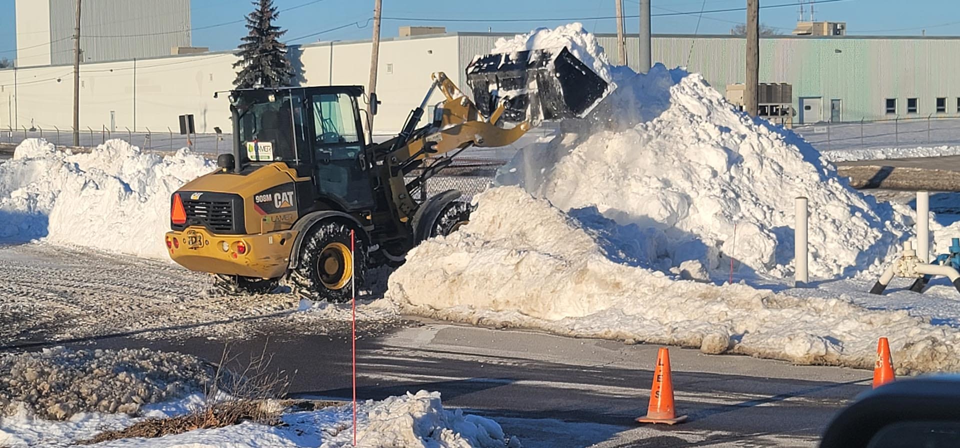 Plow truck clearing a commercial lot in Quinte West