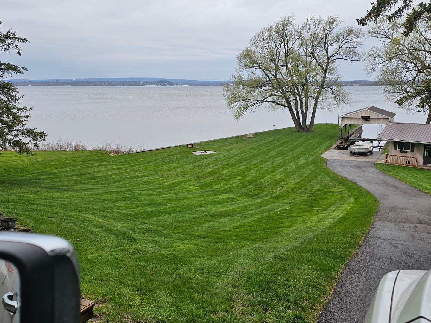 Waterfront property lawn and walkway in spring