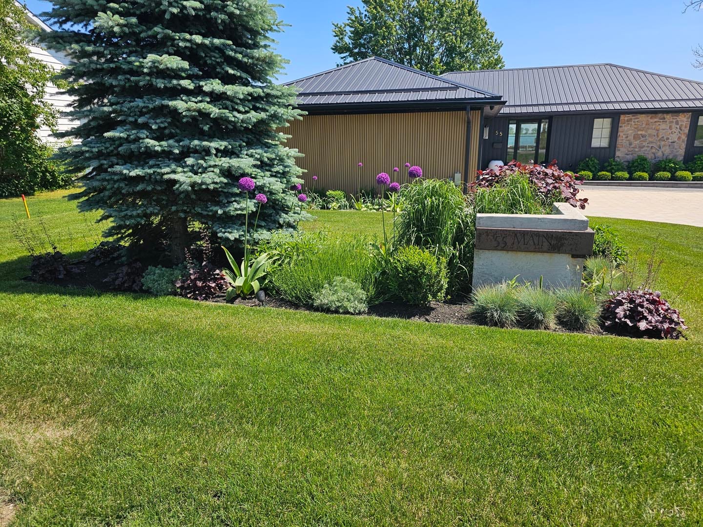 Shrub and perennial bed beside a mown lawn