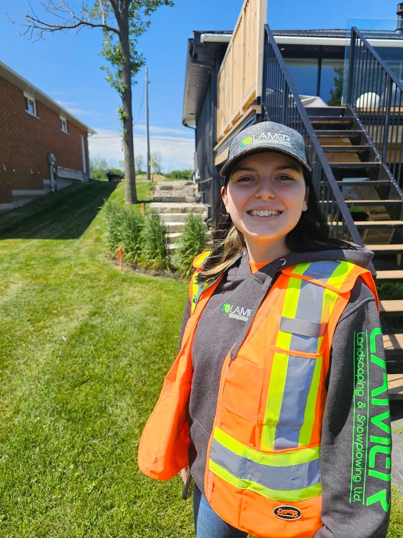 Lamer crew member in a high-visibility vest on a residential property