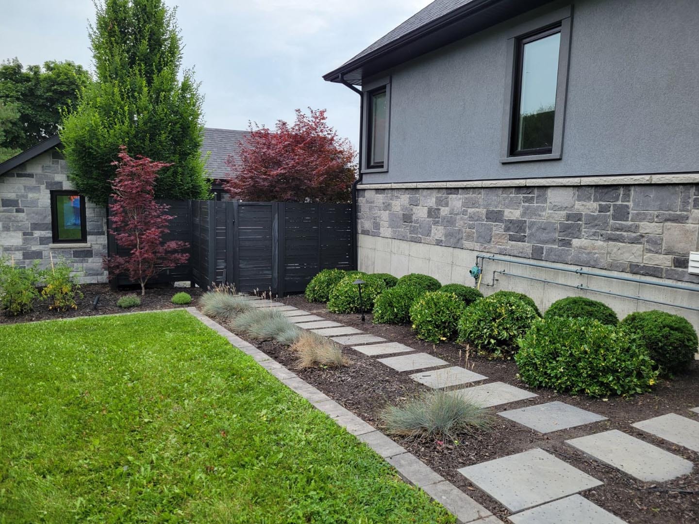 Modern front garden bed with stepping stones