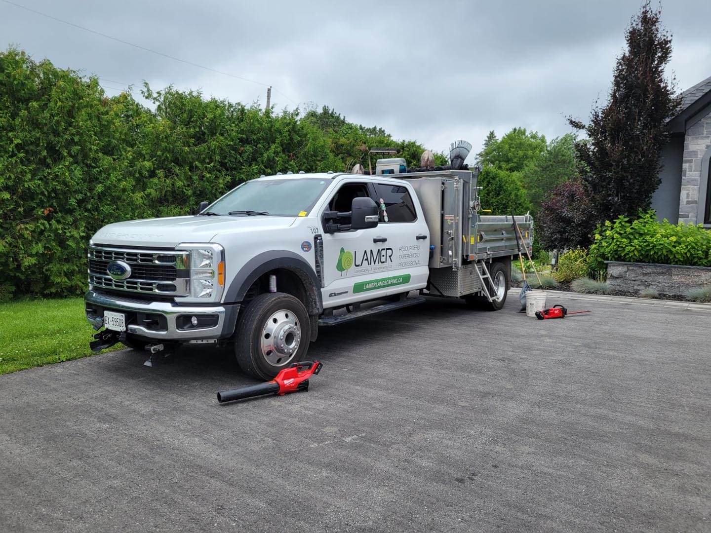 Lamer Landscaping service truck and trailer on a residential job